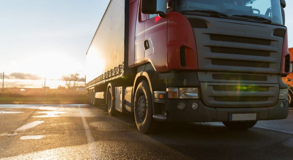 Red truck on the road — Whybirds Transport in Raceview, QLD